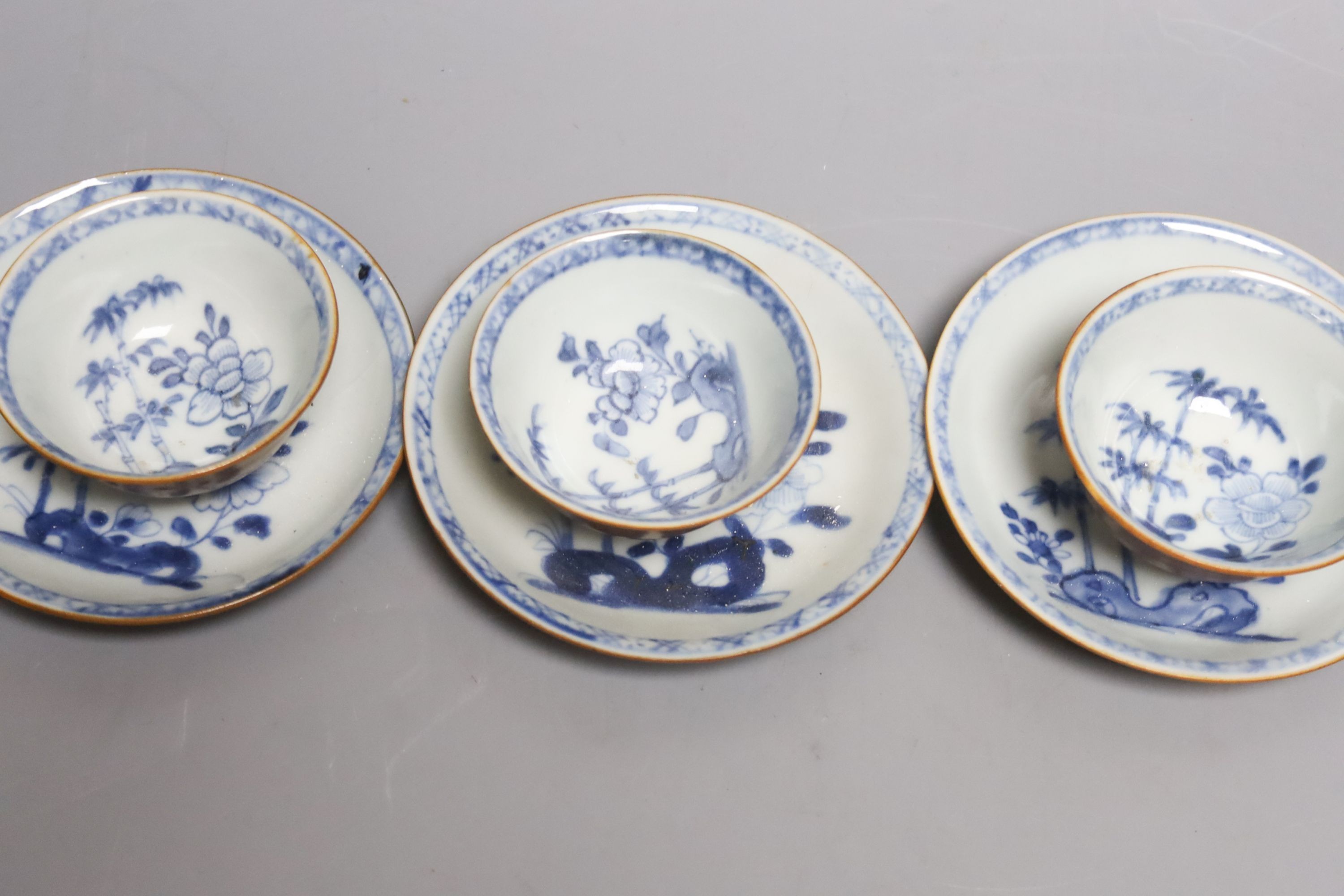 A set of four Chinese Nanking Cargo blue and white teabowls and saucers, with cafe au lait ground